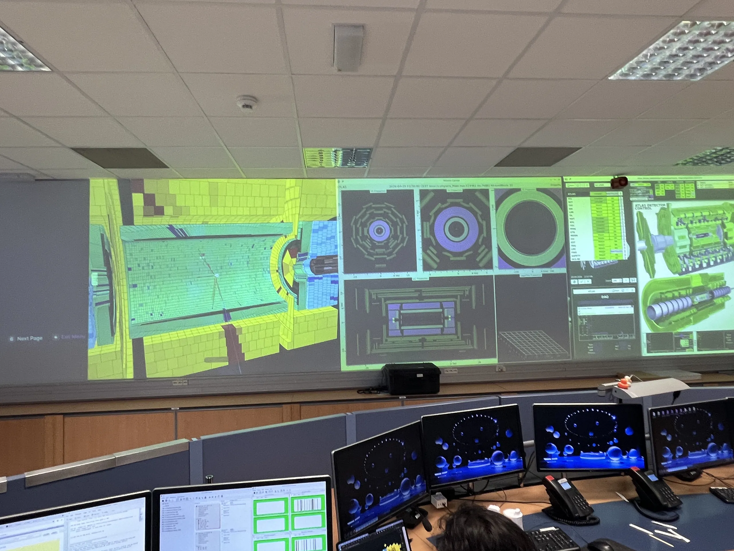 CGVWeb open on the operator consoles and the main wall of the ATLAS Control Room